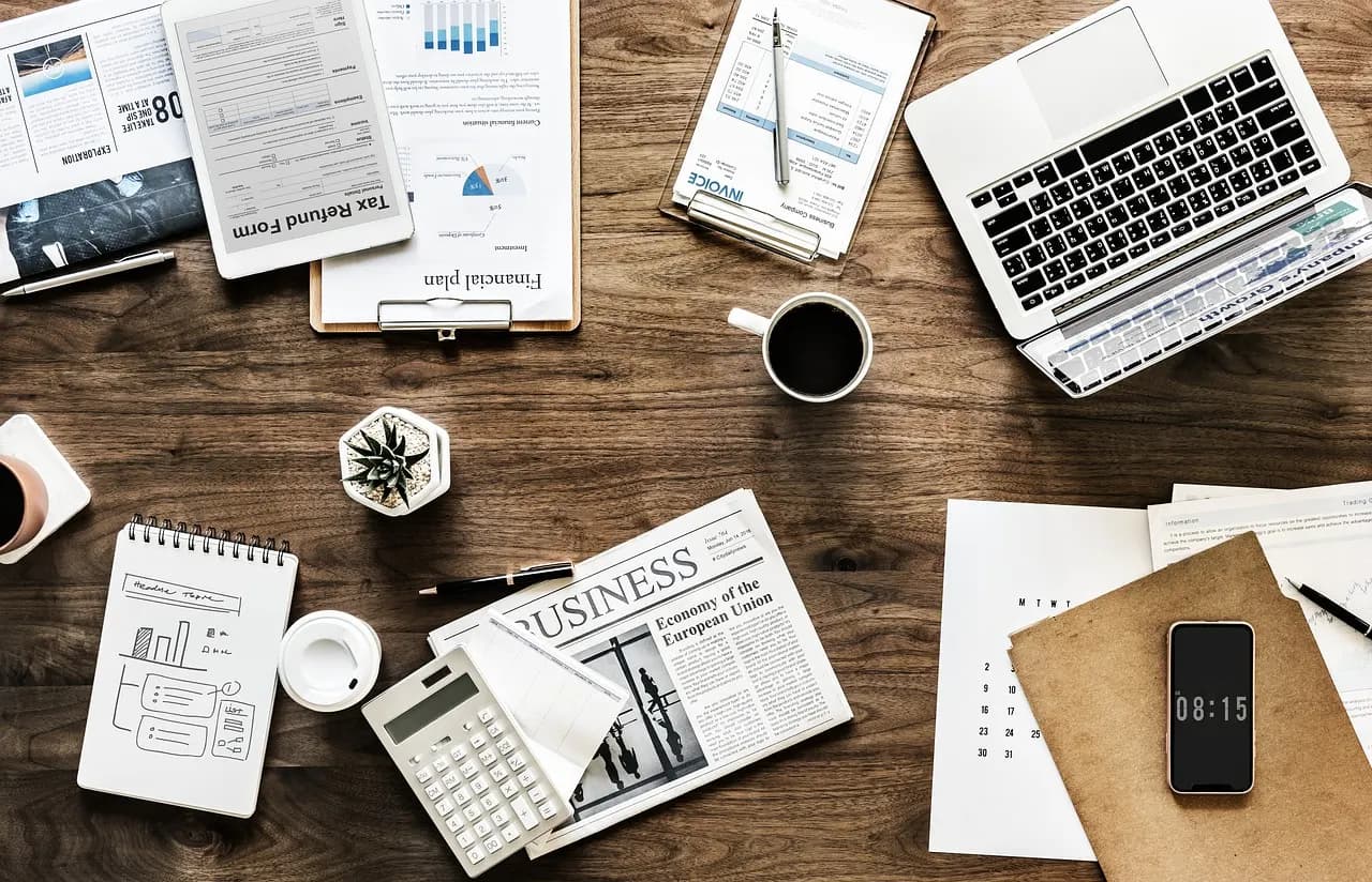 Business planning desk with a laptop, documents and financial charts